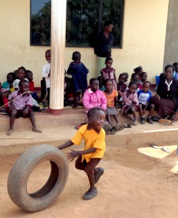 boy with tire at Mercy school
