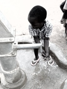 child at water pump